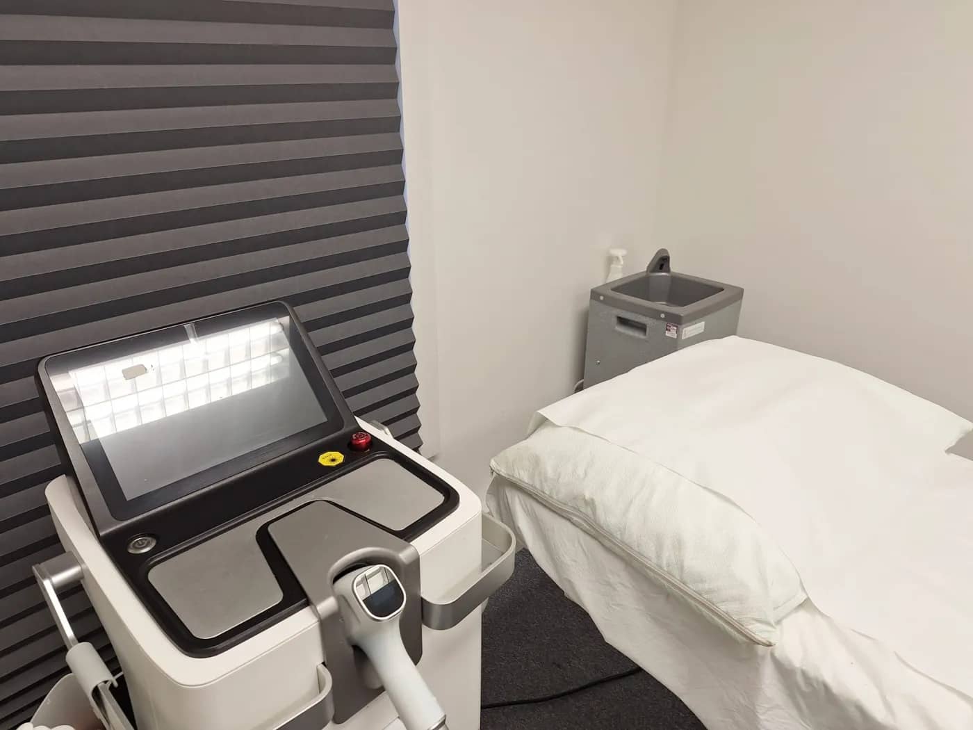 The diode laser beside the treatment bed in the laser room The diode laser beside the treatment bed in the laser room