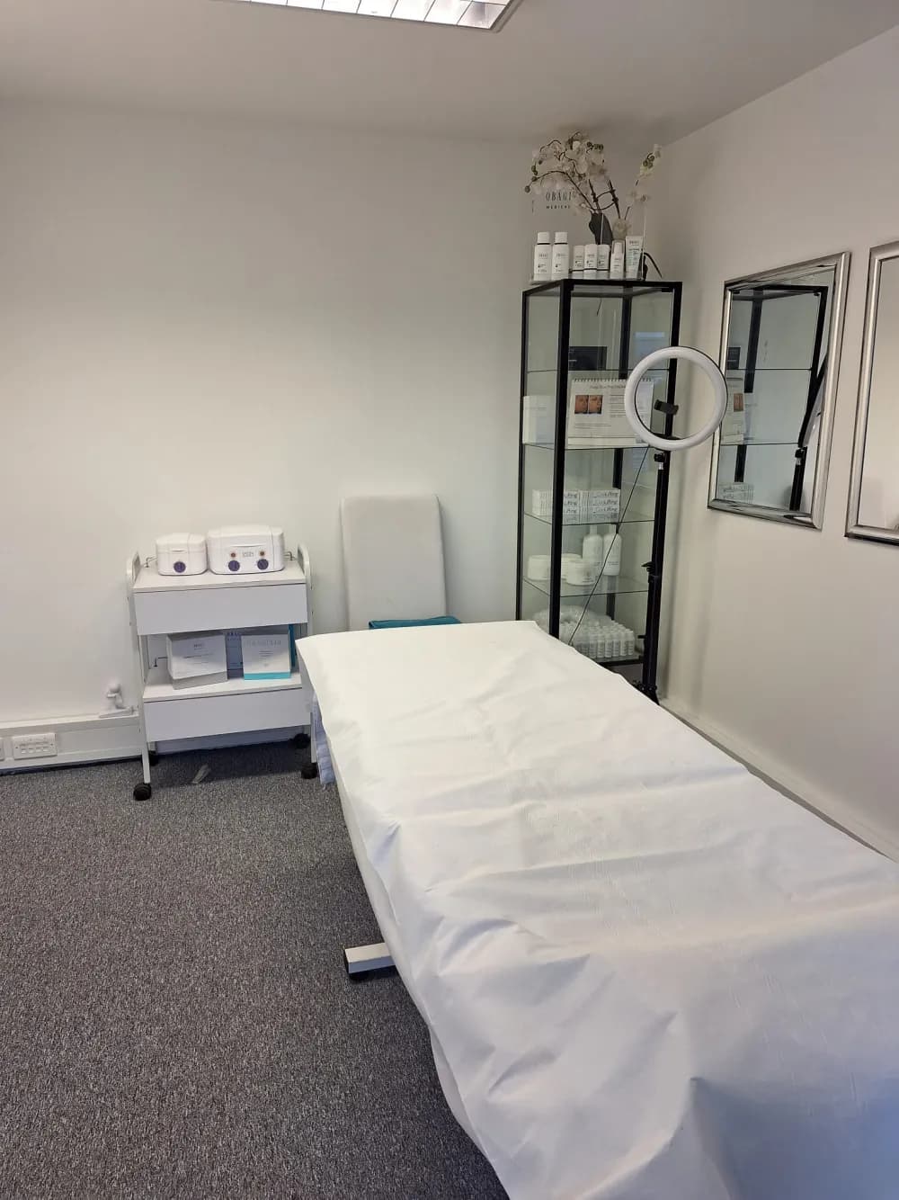 A treatment room at Laserlite Clinic with the Obagi skincare cabinet A treatment room at Laserlite Clinic with the Obagi skincare cabinet
